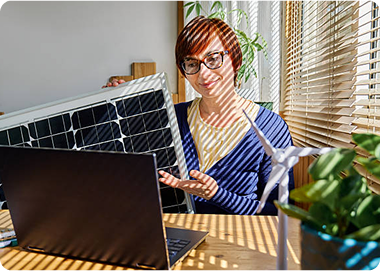 Satisfied customer with solar panels and laptop